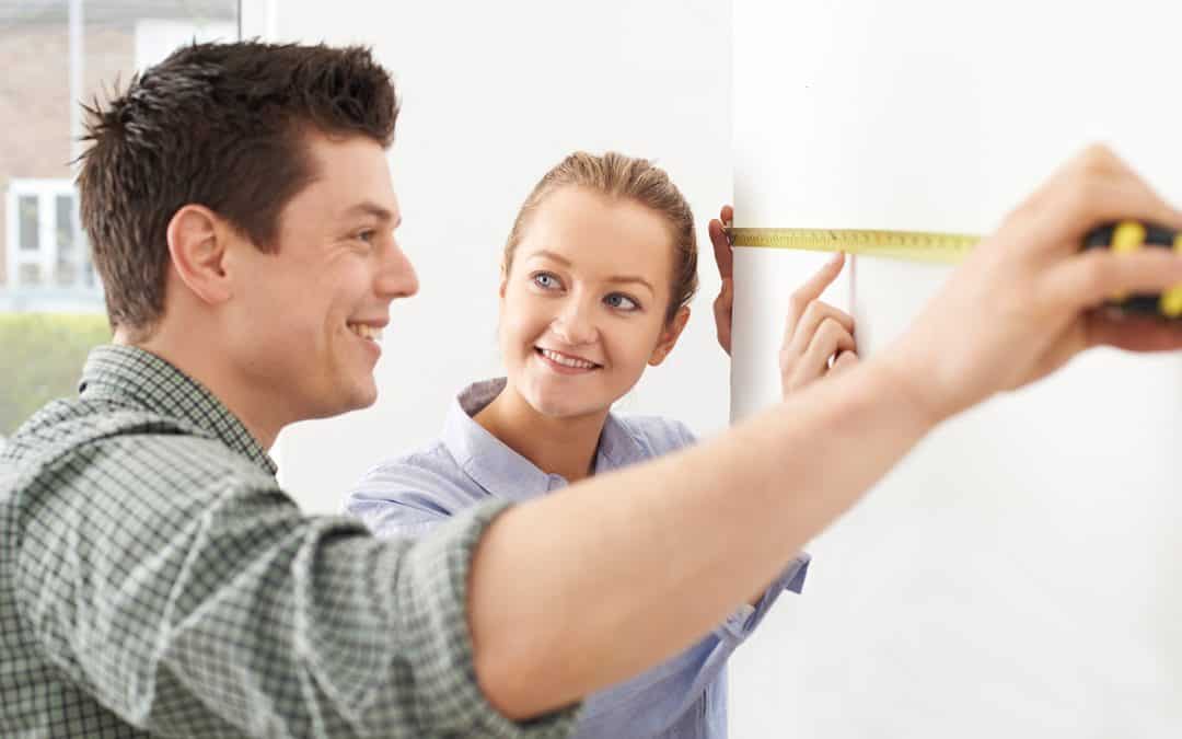 Couple Measuring Kitchen Wall